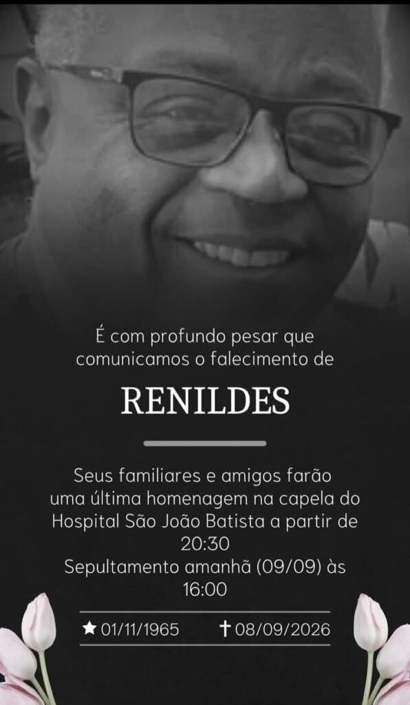Santinho em preto e branco com foto do rosto de de Renildes: homem negro, robusto, cabelos grisalhos cortados rente, óculos de armação preta, nariz largo. Ele olha para nós e sorri. Texto: "É com profundo pesar que comunicamos o falecimento de Renildes. Seus familiares e amigos farão uma última homenagem na capela do hospital São João Batista a partir de 20h30. Sepultamento amanhã (9/9) às 16h. Nascimento: 01/011/1965. Falecimento: 08/09/2026.